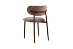 Chaise de salle à manger NONYA en tissu sable, piètement métal effet bois — en situation