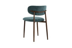 Chaise de salle à manger NONYA en tissu bleu-vert, piètement métal effet bois — en situation